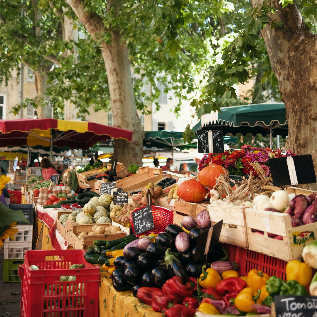 A stall at a French market selling fruit and vegetables.